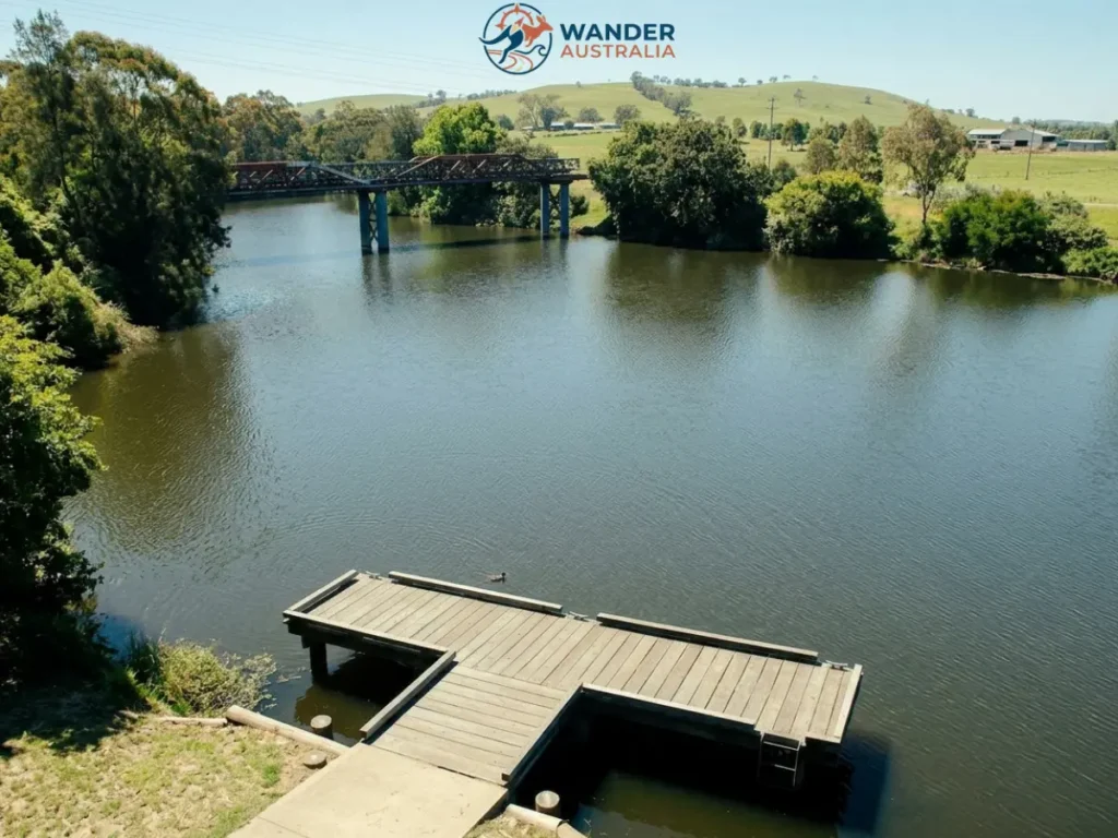 Boat dock and historic bridge over the Williams River, Clarence Town NSW image