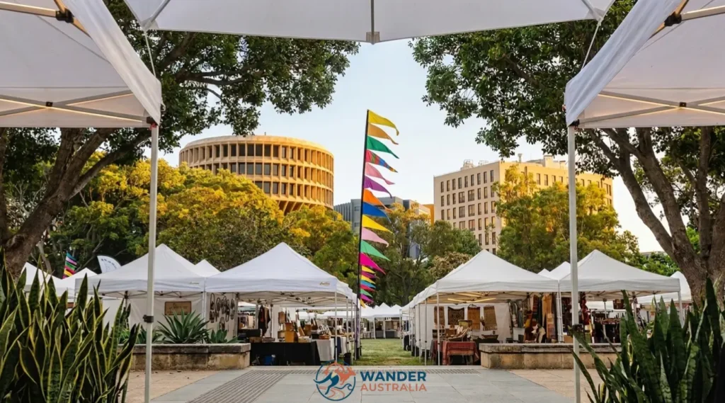 The Olive Tree Market stalls in Newcastle CBD with city skyline image